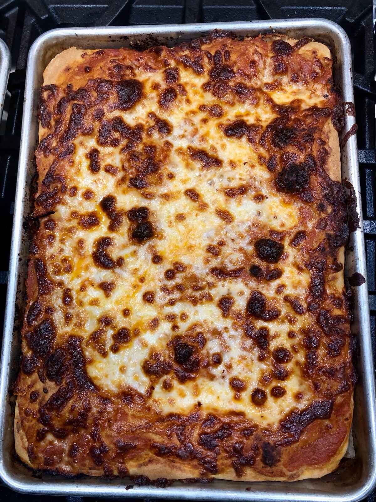 A rectangular cheese pizza, Sicilian or “grandma” style