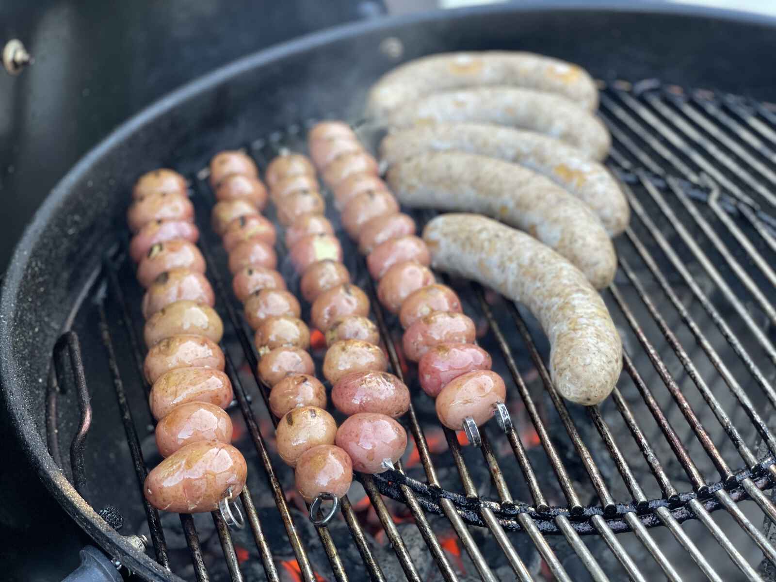 sausages and potatoes on a grill