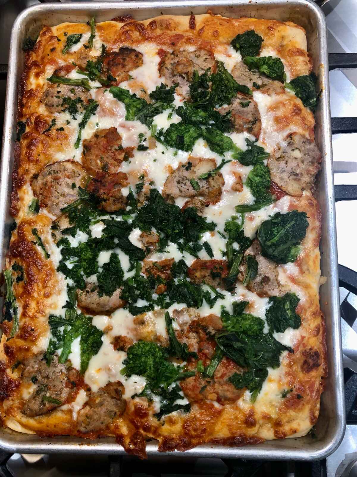 A meatball and broccoli rabe pizza