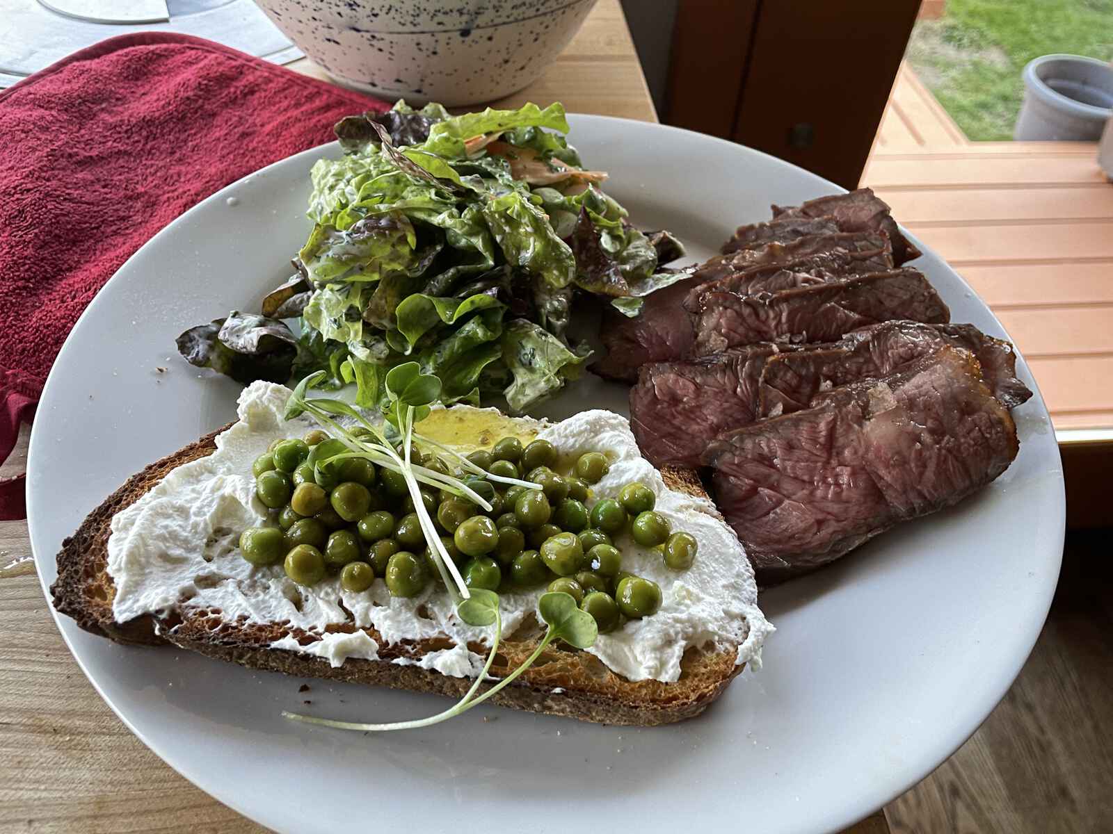 Steak, salad and toast on a plate